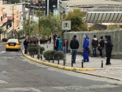 Personas en fila en el exterior del Centro de Convenciones Eugenio Espejo de Quito para someterse a una prueba de coronavirus.
