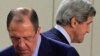 U.S. Secretary of State John Kerry (R) walks behind Russian Foreign Minister Sergei Lavrov (L) at the start of a NATO-Russia foreign ministers meeting in Brussels, April 23, 2013.