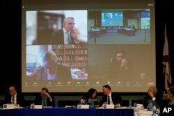 FILE - New College of Florida's board of trustees, including conservative activist Christopher Rufo, who is seen on screen, lower right, attending remotely, meet to vote on proposed changes to the school, Tuesday, Feb. 28, 2023, in Sarasota, Fla. (AP Photo/Rebecca Blackwell)
