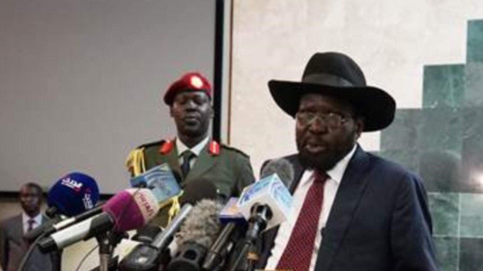 South Sudanese President Salva Kiir (R), shown delivering a speech to lawmakers, has retracted a statement that was widely perceived as a threat against journalists. 