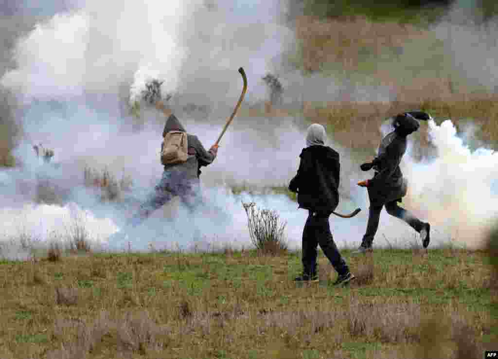 Mapuche indigenous people clash with the police during a protest against the Chilean government to demand the release of an imprisoned spiritual authority, or "machi," in Comuna Imperial, Aug. 17, 2020.