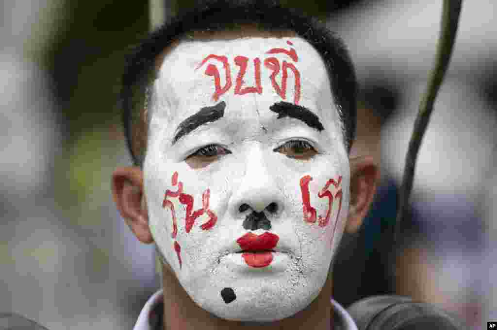 A pro-democracy demonstrator with a face paint that reads 'End it with our generation' during a protest at Thammasat University in Pathum Thani, north of Bangkok, Thailand.