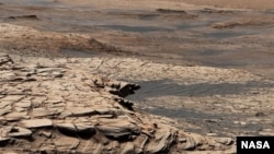 This photo, compiled from 28 images, shows the view from NASA’s Curiosity Mars rover on April 9, 2020. It shows the landscape of the Stimson sandstone formation in Gale Crater. (Photo Credit: NASA/JPL-Caltech/MSSS)