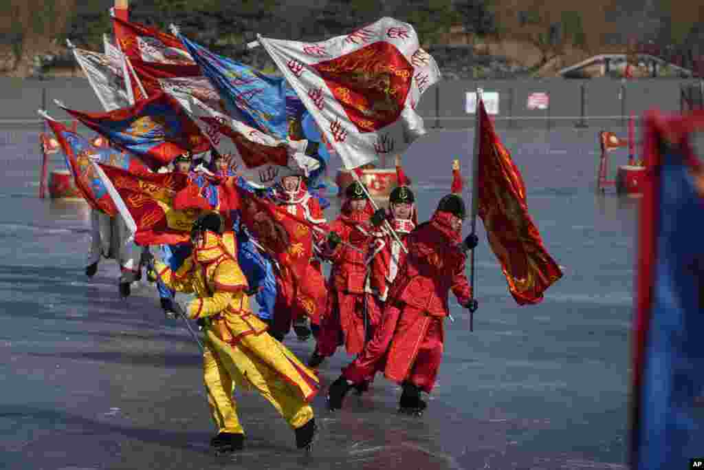 Chinese artists dressed in traditional costumes perform an ice frolic on a frozen lake at the Yuanmingyuan Garden during the second day of the Lunar New Year celebrations in Beijing.