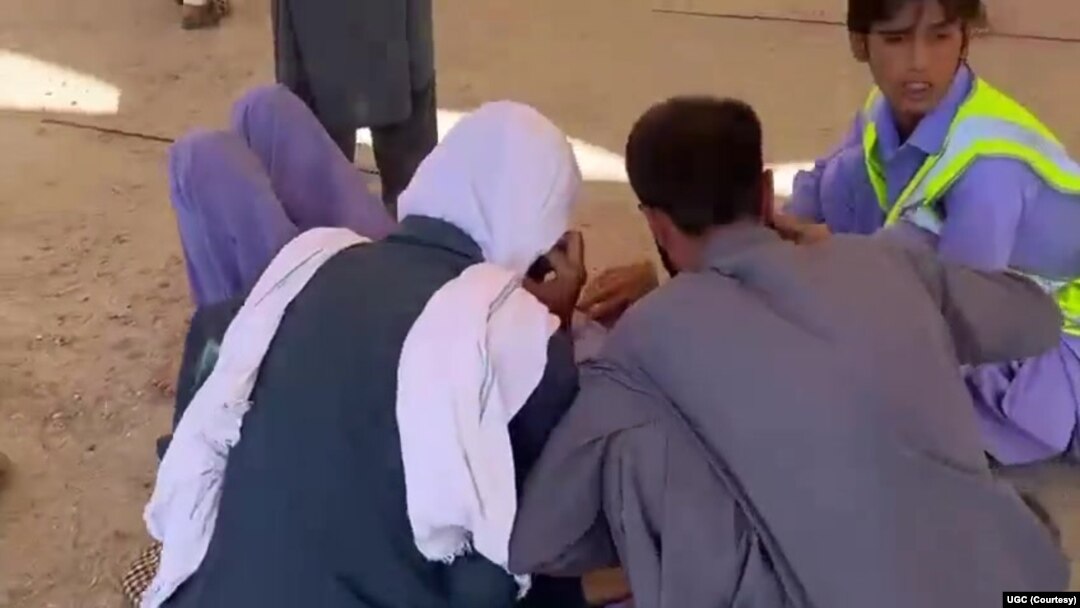 This screenshot of a video sent to VOA Persian appears to show residents of southeast Iran's Zahedan city tending to a wounded man after police shot at protesters on Sept. 30, 2022. (UGC)