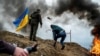 FILE PHOTO: A civilian trains to throw Molotov cocktails to defend the city