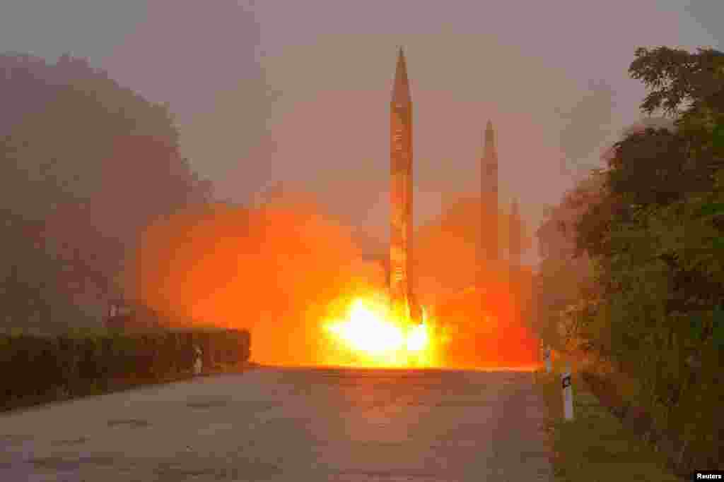 Ballistic rockets are seen launching during a drill by the Hwasong artillery units of the KPA Strategic Force in this undated picture provided by KCNA in Pyongyang, North Korea.