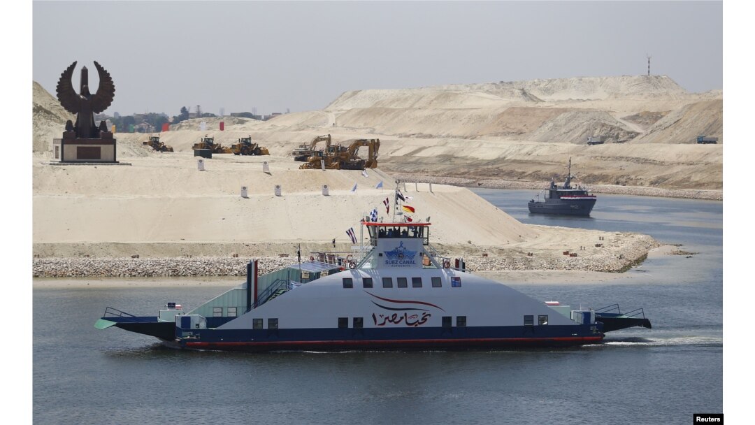 The ship Long Life Egypt crosses a new section of the Suez Canal in Ismailia, Egypt, Aug. 6, 2015. The canal was extended in hopes of powering an economic turnaround.