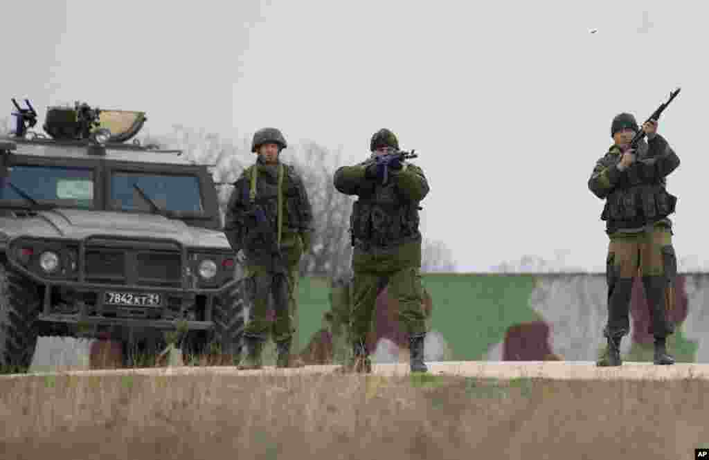 Russian soldiers fire warning shots at the Belbek air base, outside Sevastopol, Ukraine, March 4, 2014.