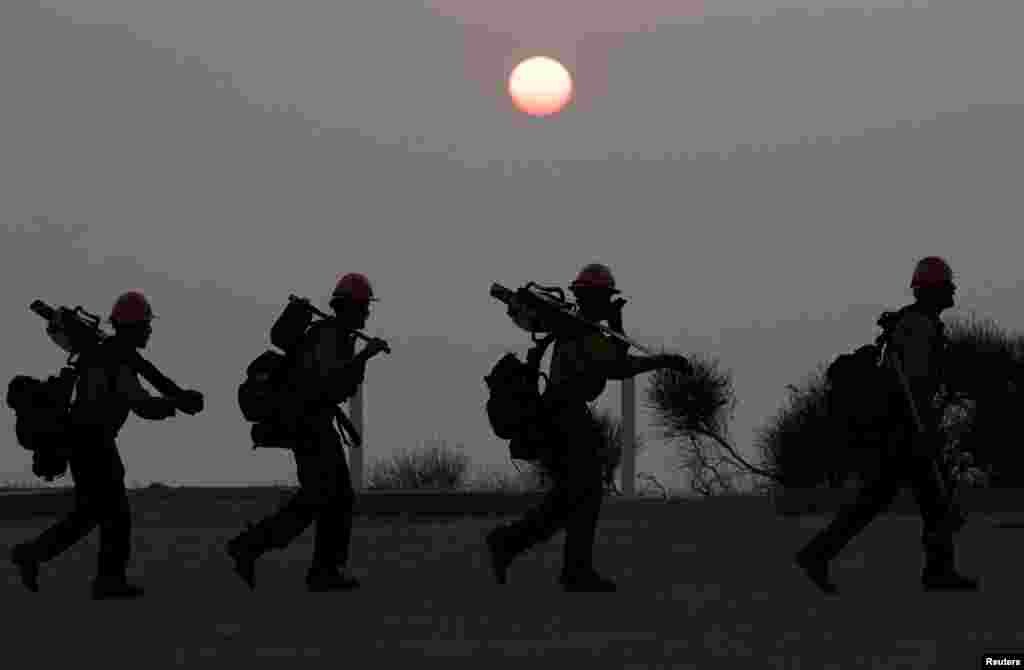 A hotshots crew walks back after working on a fire line near Mount Wilson Observatory while battling the Bobcat Fire in Los Angeles, California, Sept. 14, 2020.