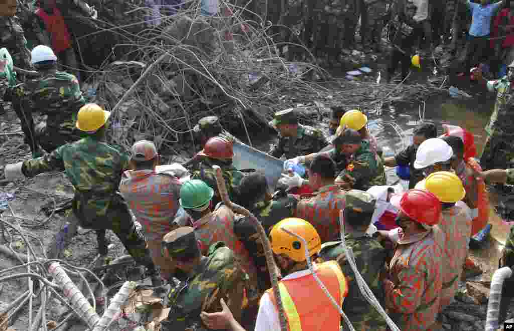 Rescuers carry a survivor pulled out from the rubble of a building that collapsed in Saver, near Dhaka, Bangladesh, May 10, 2013.