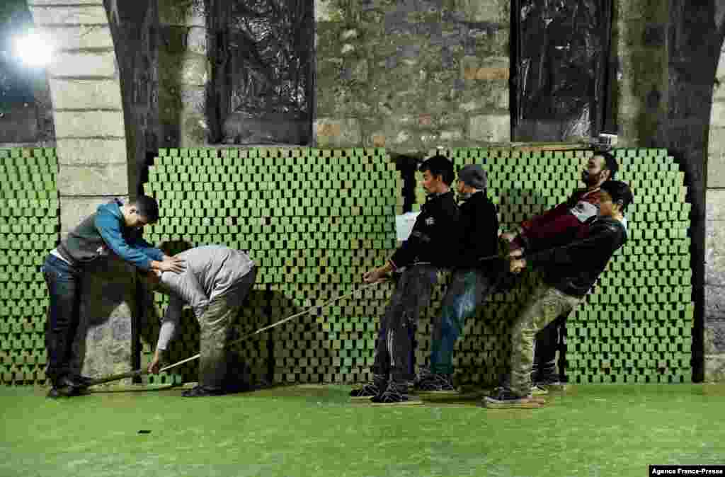 Syrian workers cut laurel soap at the Jbaili soap factory, an 800-year-old artisanal soap manufacturer, in the old city of Syria's northern city of Aleppo, Jan. 24, 2022.