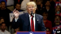 President-elect Donald Trump gestures as he speaks during a "USA Thank You" tour event in Cincinnati, Dec. 1, 2016.