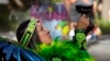 A member of the Grupo Coatlicue begins a traditional Aztec dance, an agricultural prayer ceremony in motion, during an Indigenous Peoples' Day event, Monday, Oct. 14, 2024, in Phoenix, Arizona. (AP Photo/Ross D. Franklin)