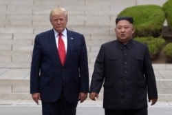 President Donald Trump, left, meets with North Korean leader Kim Jong Un at the North Korean side of the border at the village of Panmunjom in Demilitarized Zone, Sunday, June 30, 2019. (AP Photo/Susan Walsh)