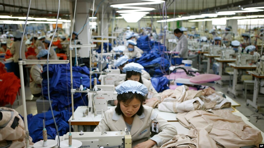FILE - North Korean workers assemble jackets at a factory of a South Korean-owned company at the jointly run Kaesong Industrial Complex in Kaesong, North Korea, Dec. 19, 2013.