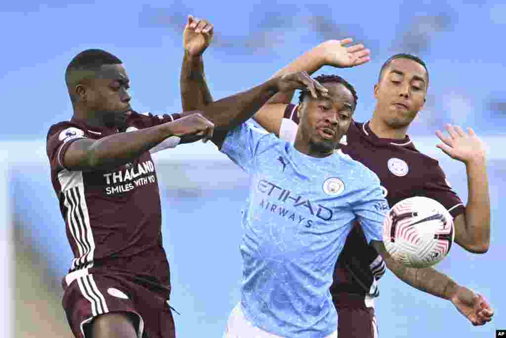 Leicester's Nampalys Mendy, left vies for the ball with Manchester City's Raheem Sterling, center and Leicester's Youri Tielemans during the English Premier League soccer match between Manchester City and Leicester City at the Etihad stadium in Manchester, England.