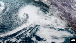 Citra satelit yang disediakan oleh NOAA ini menunjukkan sistem badai yang mendekati Pantai barat AS, Selasa, 3 Januari 2023, pukul 18.36 petang waktu setempat. (NOAA via AP)