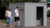 People walk past a reinforced-concrete bomb shelter installed on a street in Kursk, Russia, on Aug. 28, 2024. The sign on the structure reads, "Shelter."