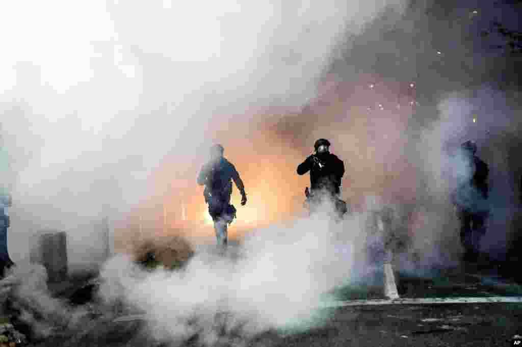 Federal officers use crowd control munitions to disperse Black Lives Matter protesters outside the Mark O. Hatfield United States Courthouse in Portland, Oregon.