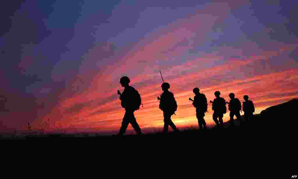 South Korean marines patrol during sunset on the South Korea-controlled island of Yeonpyeong near the 'northern limit line' sea boundary with North Korea.