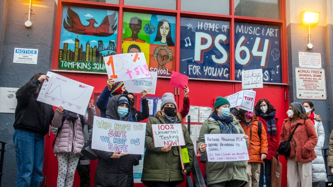 Teachers from the Earth School speak out on issues related to lack of coronavirus testing outside P.S. 64, Dec. 21, 2021, in New York. (AP Photo/Brittainy Newman, File)
