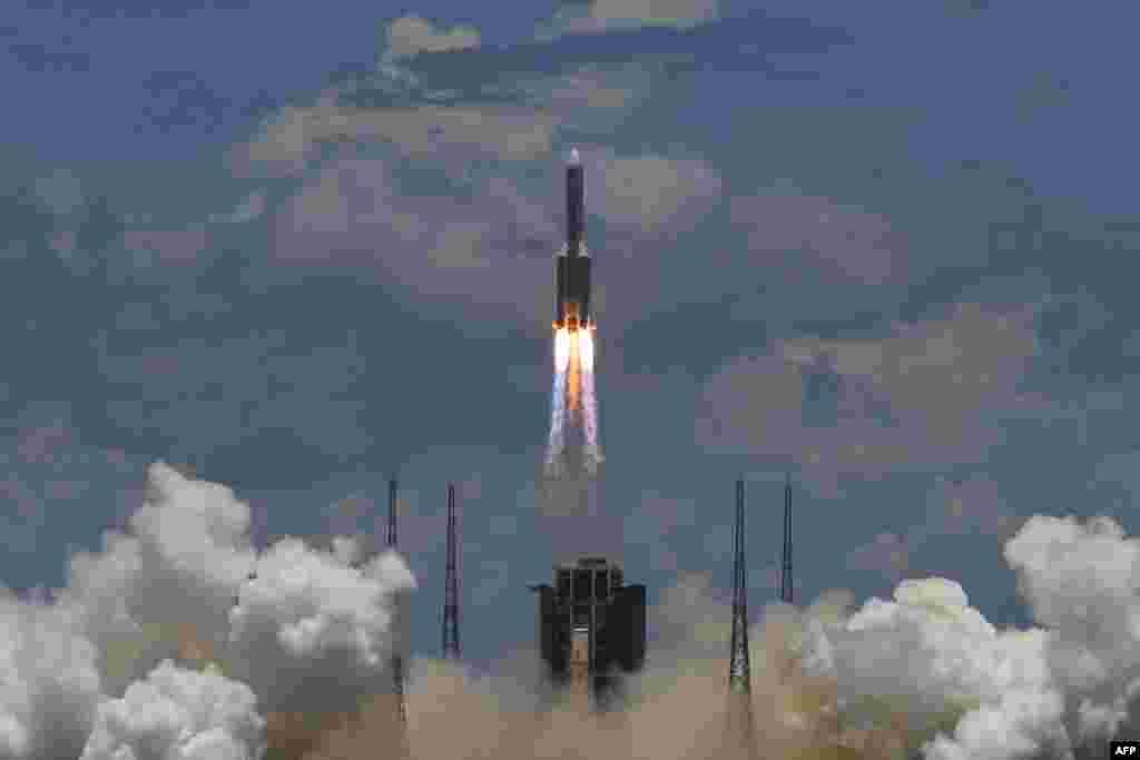 A Long March-5 rocket, carrying an orbiter, lander and rover as part of the Tianwen-1 mission to Mars, lifts off from the Wenchang Space Launch Centre in southern China's Hainan Province.