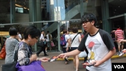 學民思潮發起人之一林朗彥(右)向途人派發宣傳學民思潮政改方案的單張 (美國之音湯惠芸拍攝)
