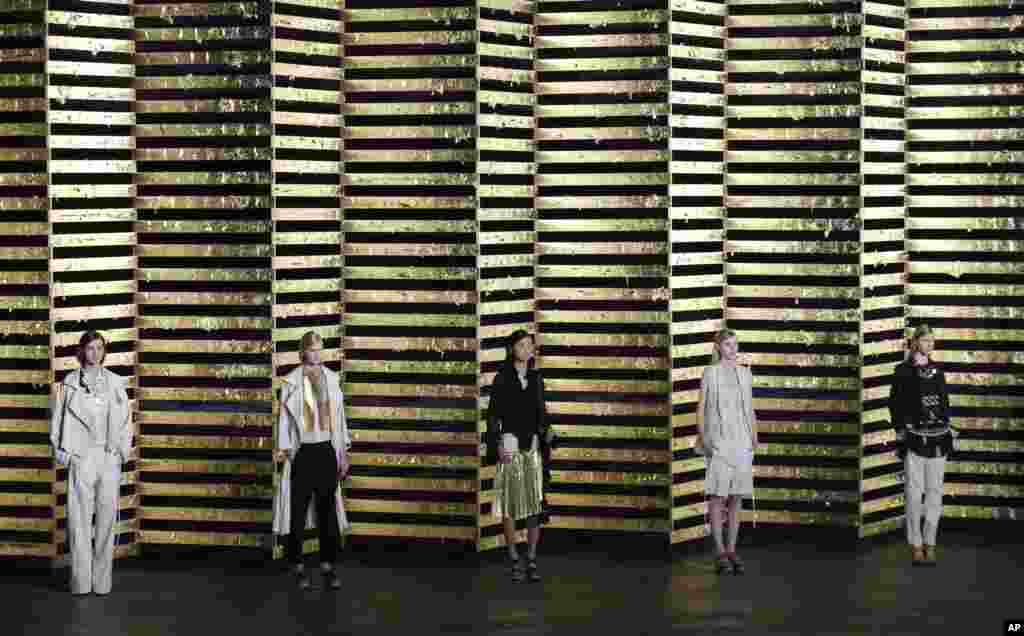 Models wear creations for Belgian fashion house Dries van Noten's ready-to-wear Spring/Summer 2014 fashion collection, presented in Paris, France.