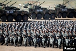 Soldiers of China's People's Liberation Army (PLA) get ready for the military parade to commemorate the 90th anniversary of the foundation of the army at Zhurihe military training base in Inner Mongolia Autonomous Region, China, July 30, 2017. China Daily