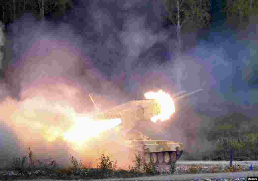 A Russian "TOS-1 Buratino" multiple rocket launcher fires during the "Russia Arms Expo 2013" 9th international exhibition of arms, military equipment and ammunition, in the Urals city of Nizhny Tagil.