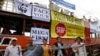 FILE - Cambodian NGO workers hold a cut-outs of threatened species during protests in Phnom Penh, Cambodia, Sept. 11, 2014.