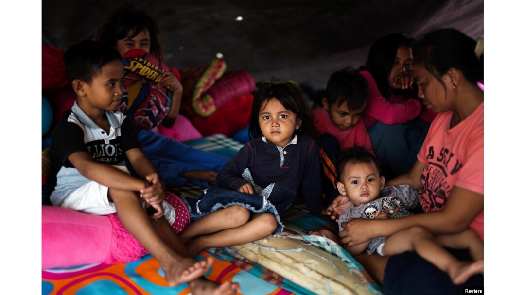 A family affected by the earthquake and tsunami is pictured at a temporary shelter in Donggala, Central Sulawesi, Indonesia Oct. 3, 2018.