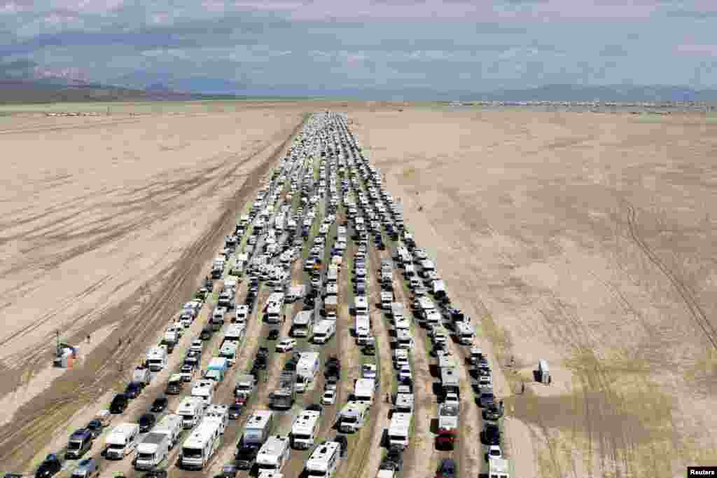Vehicles are seen departing the Burning Man festival in Black Rock City, Nevada, Sept. 4, 2023. Hundreds of Burning Man attendees left on Labor Day, after a rainstorm turned the site into mud.