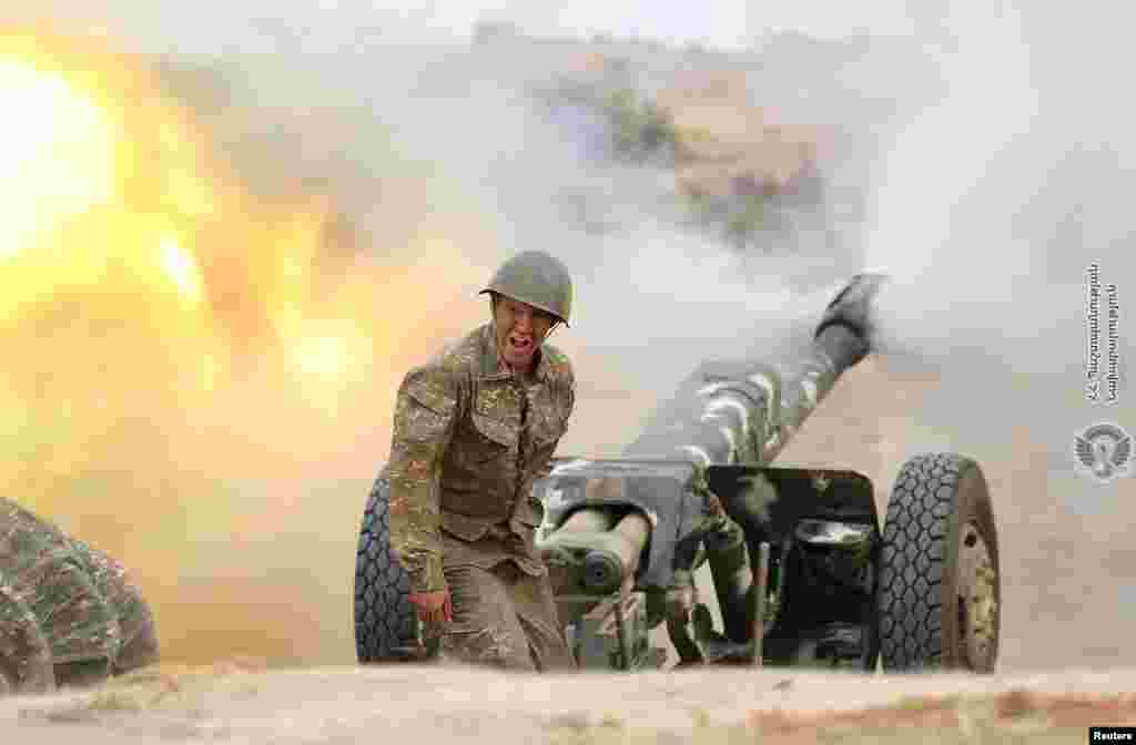 An ethnic Armenian soldier fires an artillery piece during fighting with Azerbaijan's forces in the breakaway region of Nagorno-Karabakh. (Credit: Defense Ministry of Armenia/Handout)
