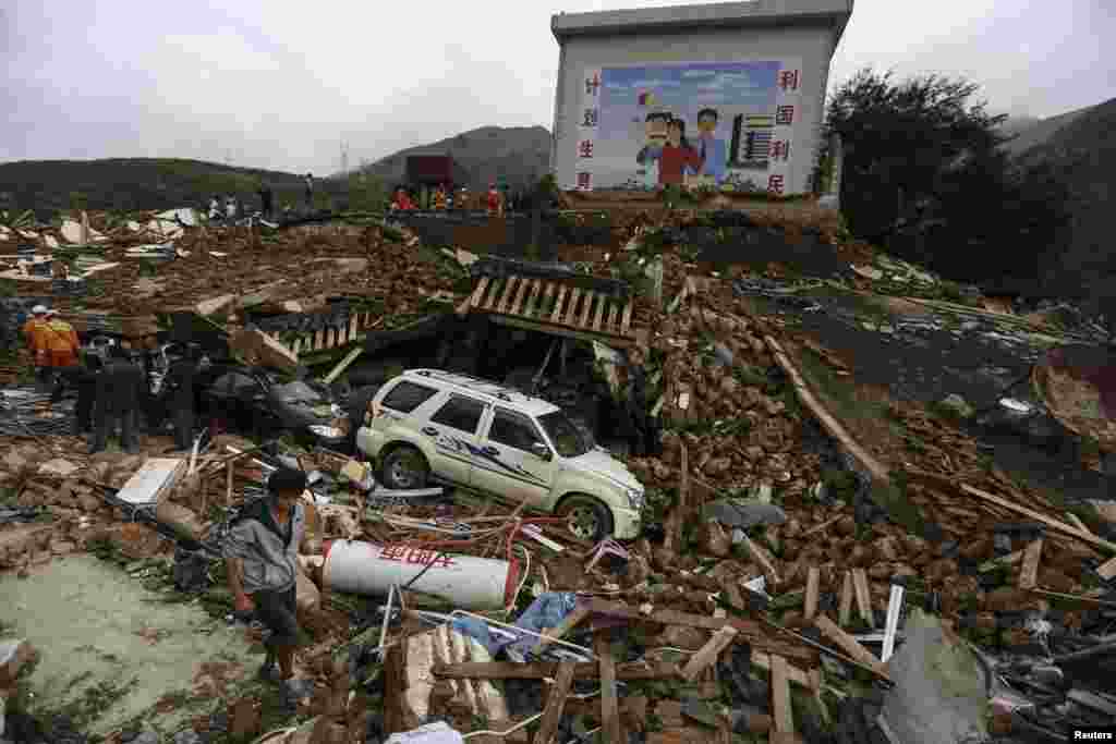 Rescuers and residents search for survivors after an earthquake hit Longtoushan township, Ludian county, Yunnan province, China Aug. 4, 2014. 