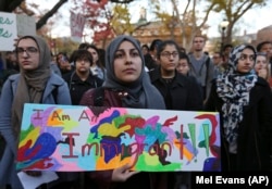 Protesting students ask Rutgers University officials to reject some of President-elect Donald Trump's plans, at Rutgers University, New York, Nov. 15, 2016.