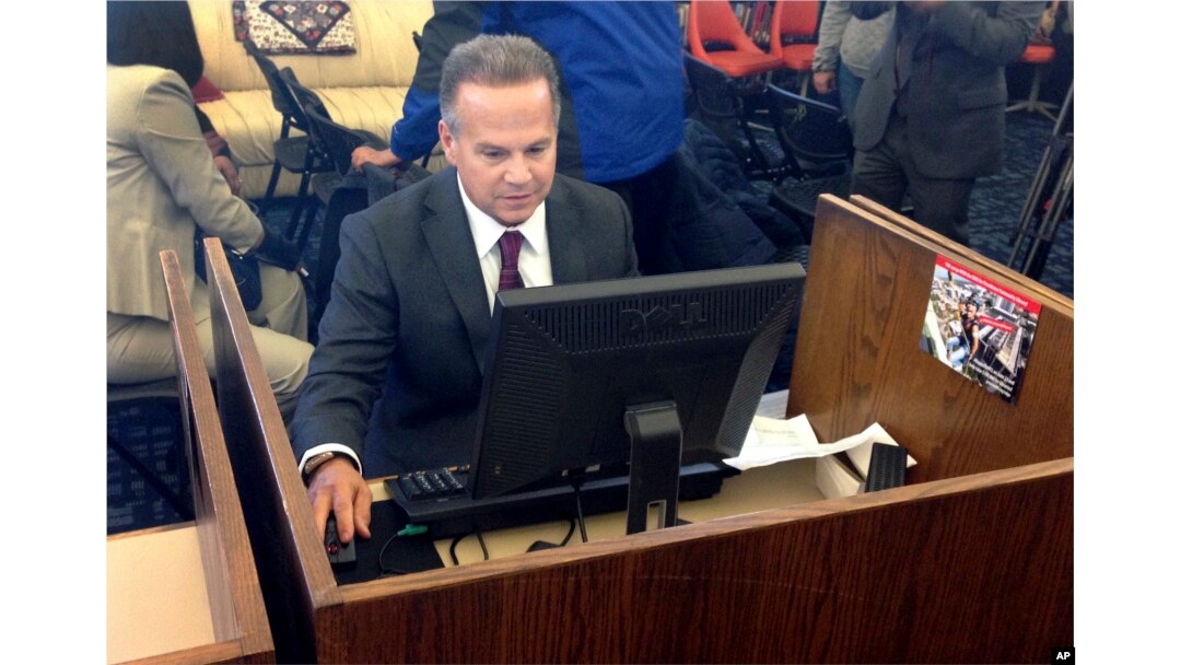 U.S. Rep. David Cicilline completes his test census form on a computer at a library in Providence, R.I., March 26, 2018.