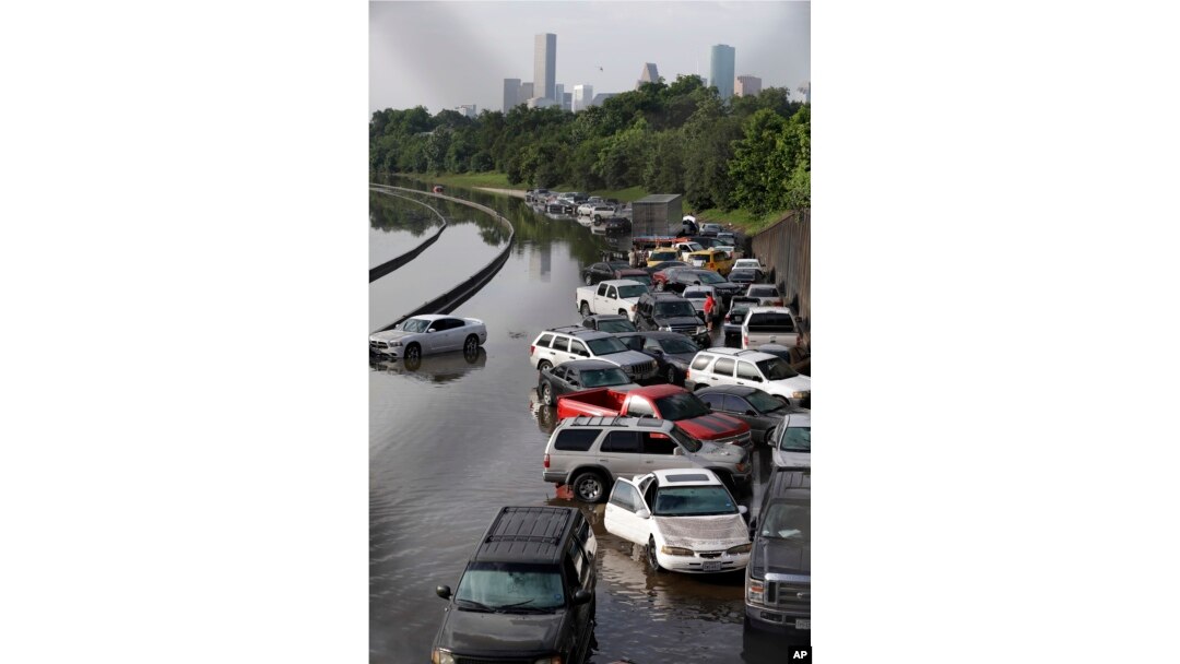 FILE- Cars remain stranded along a flooded section of Interstate 45 after heavy rains overnight in Houston, May 26, 2016. Flooding caused by heavy rains in and around Houston in the past month has killed nearly a dozen people.