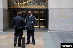 Police and security personnel stand outside 30 Rockefeller Plaza, housing the offices of U.S. President Donald Tump's lawyer Michael Cohen which was raided by the FBI in the Manhattan borough of New York City, New York, April 9, 2018.