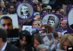 Protesters, some carrying pictures of people killed in a 1915 massacre of Armenians, hold a memorial march, in Istanbul, Turkey, April 24, 2015.
