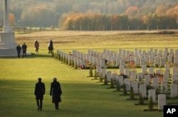 British Prime Minister Theresa May and French President Emmanuel Macron walk together after laying wreaths at the World War I Thiepval Memorial in Thiepval, France, Nov. 9, 2018. The memorial commemorates more than 72,000 men of British and South African forces who died in the Somme Offensive.