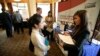Eastern Washington University student Lihn Phung, talks to Lieu Vo, an agency sales manager assistant with American Family Insurance, about internship opportunities during a National Career Fairs job fair. 