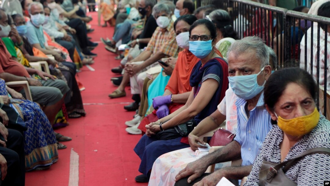People wait to receive COVID-19 vaccine in Mumbai, India, April 29, 2021.