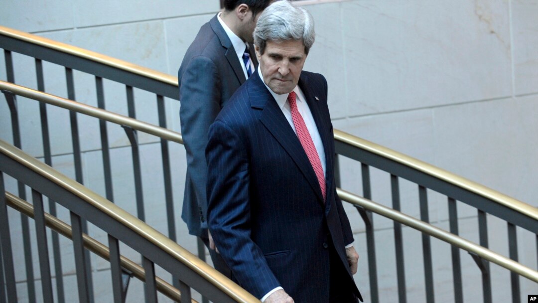 Secretary of State John Kerry walks to a closed-door briefing with Senators on the recent agreement reached between Iran and western powers on Iran's nuclear program, Dec. 11, 2013, on Capitol Hill in Washington. 