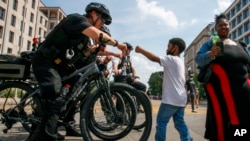 Josiah Brown, 6, of Washington, fist bumps a member of the U.S. Secret White House in Washington…