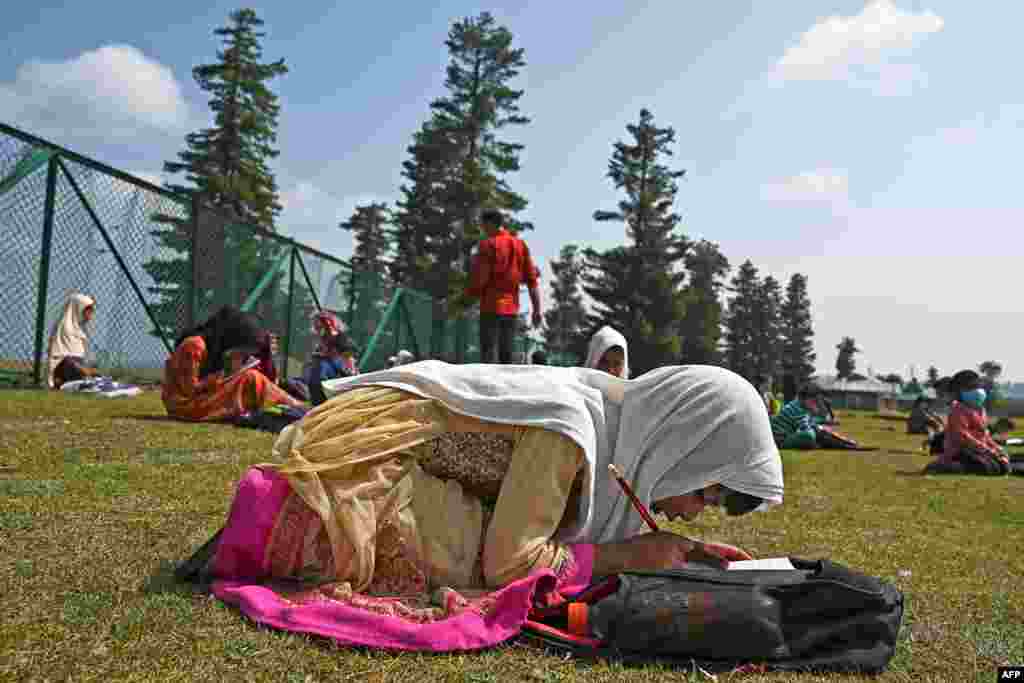 Students attend a class at their open-air school situated on top of a mountain in Doodhpathri, Indian-administered Kashmir, July 27, 2020. Schooling in restive Kashmir has been severely disrupted by the pandemic.