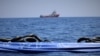 The migrant rescue ship Ocean Viking, run by two French charities, floats in the distance, as it waits in international waters between Malta and southern Italy for access to a port in this handout picture taken between Aug. 9 and 12, 2019.