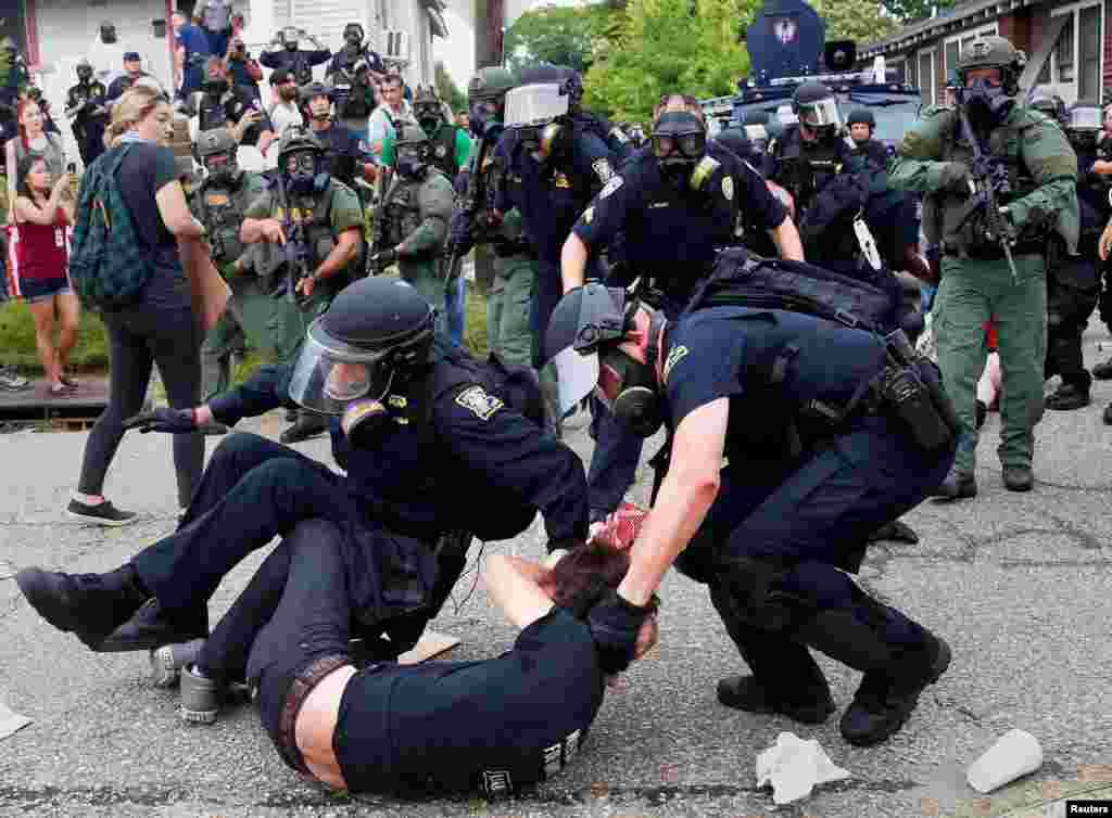 A demonstrator is detained by police during protests in Baton Rouge, Louisiana, USA.