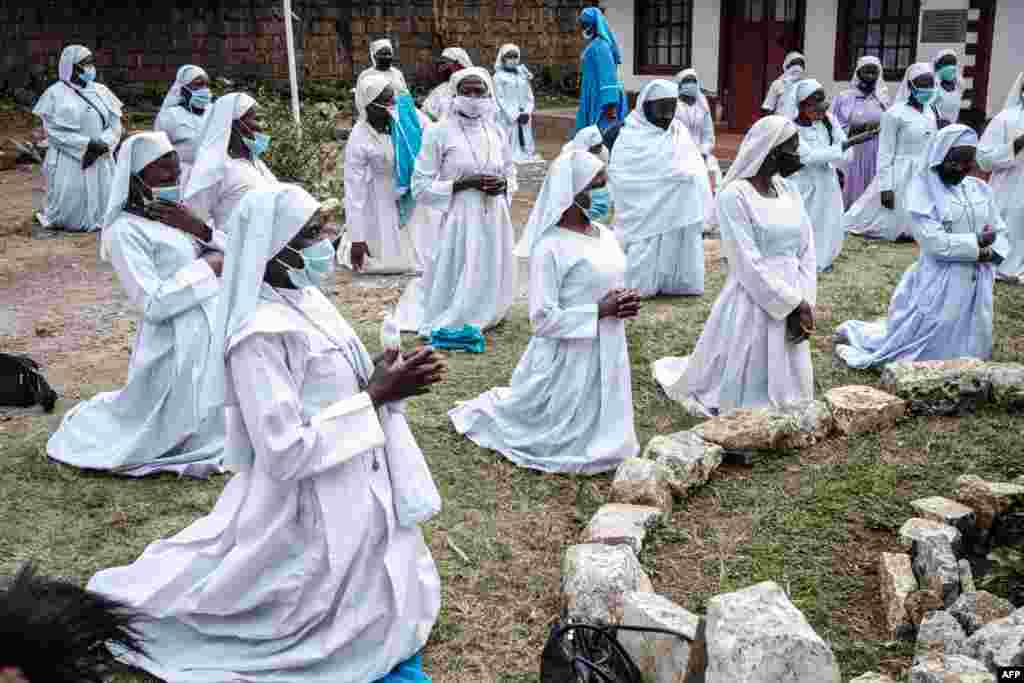 Worshipers of Legio Maria attend a prayer at their church in the Kebera slum of Nairobi after Kenya's President Kenyatta directed the places of worship to reopen under strict guidelines to curb the spread of the COVID-19.
